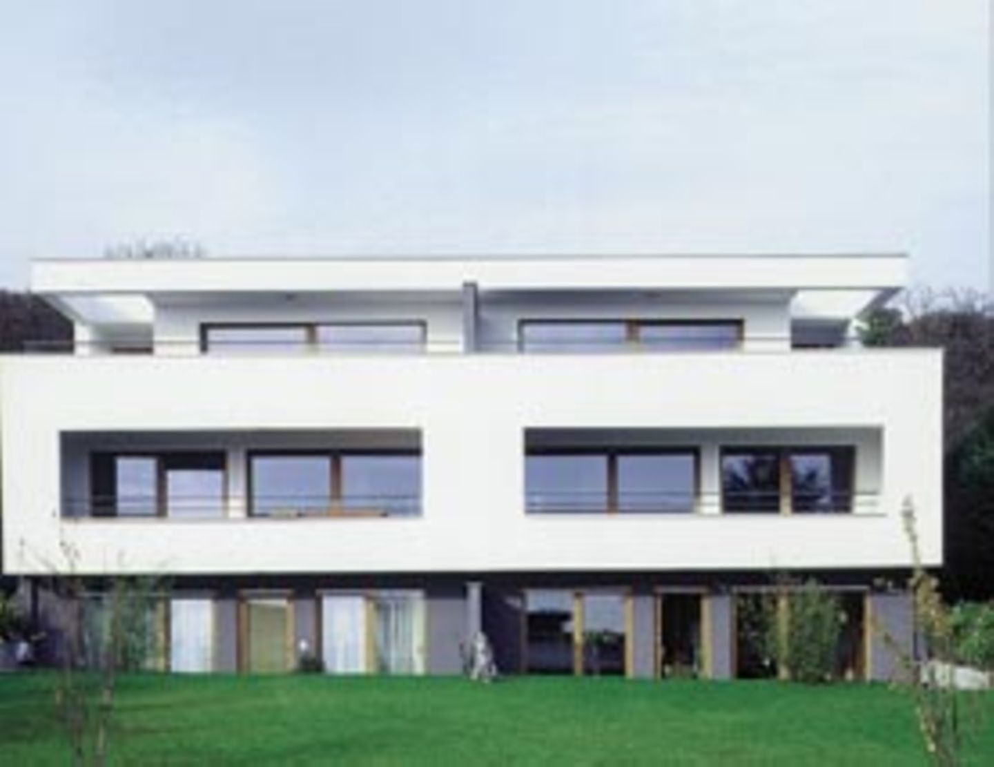 Die Ideale der klassischen Moderne prägen das Doppelwohnhaus in Rosbach. Große Fenster, Dachterrassen und Loggien öffnen sich zur Umgebung.