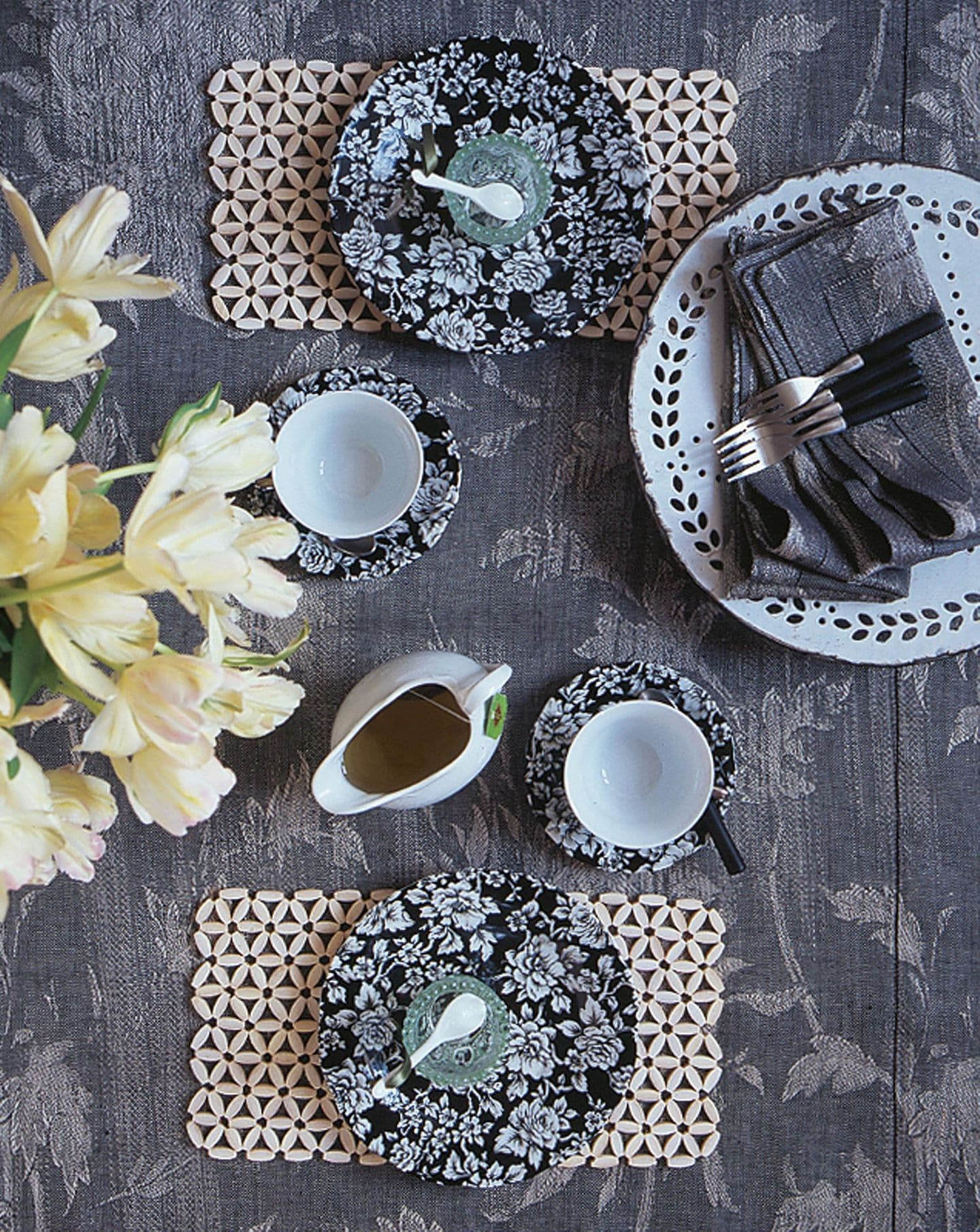 Porzellangeschirr, Tischsets und tischdecke mit Blumenmuster in Grau