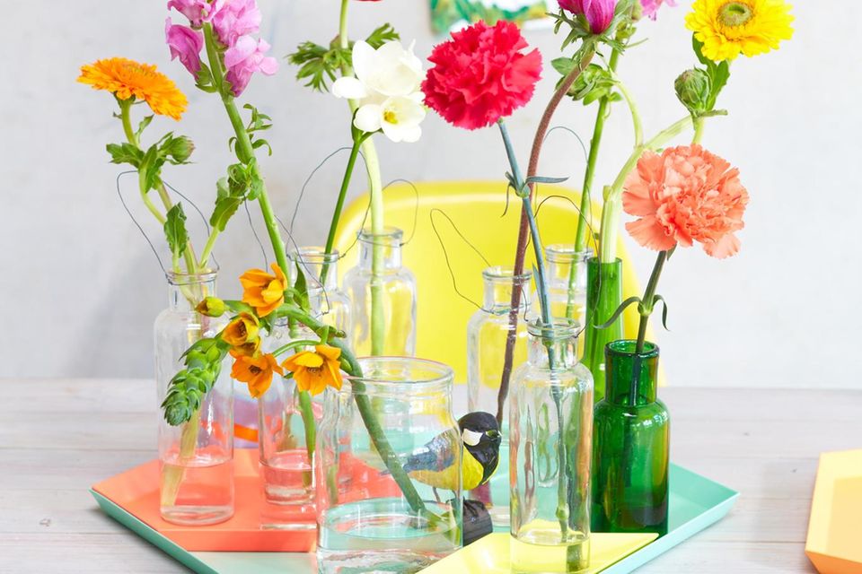 Kleine Vasen mit enzelnen bunten Blumen