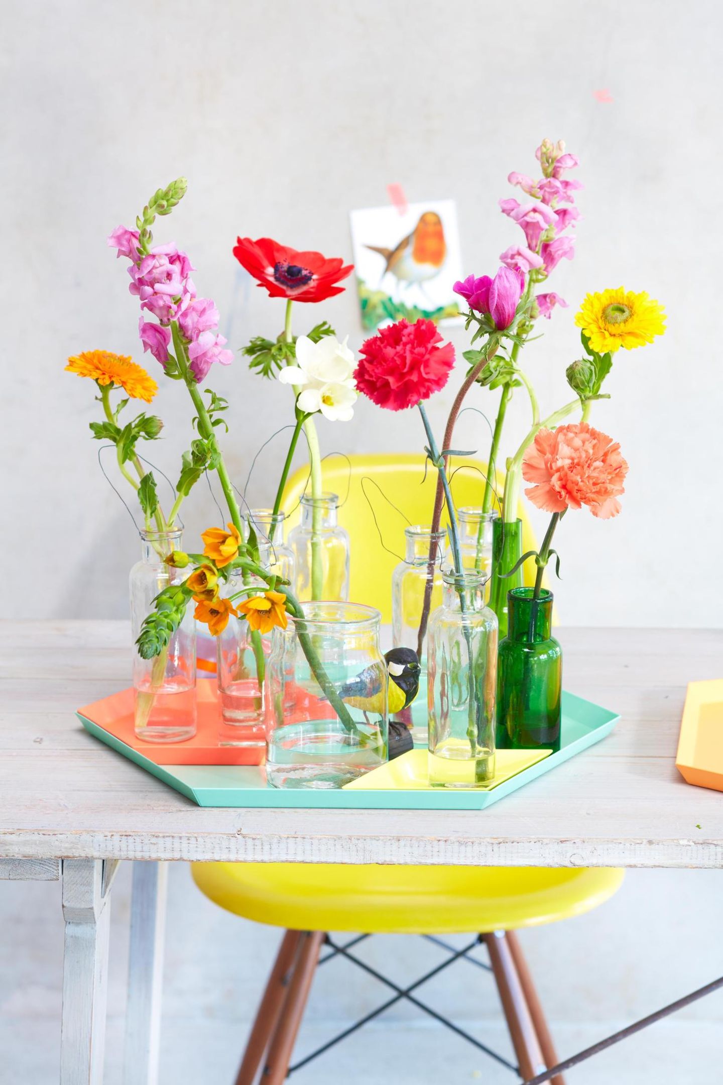 Kleine Vasen mit enzelnen bunten Blumen