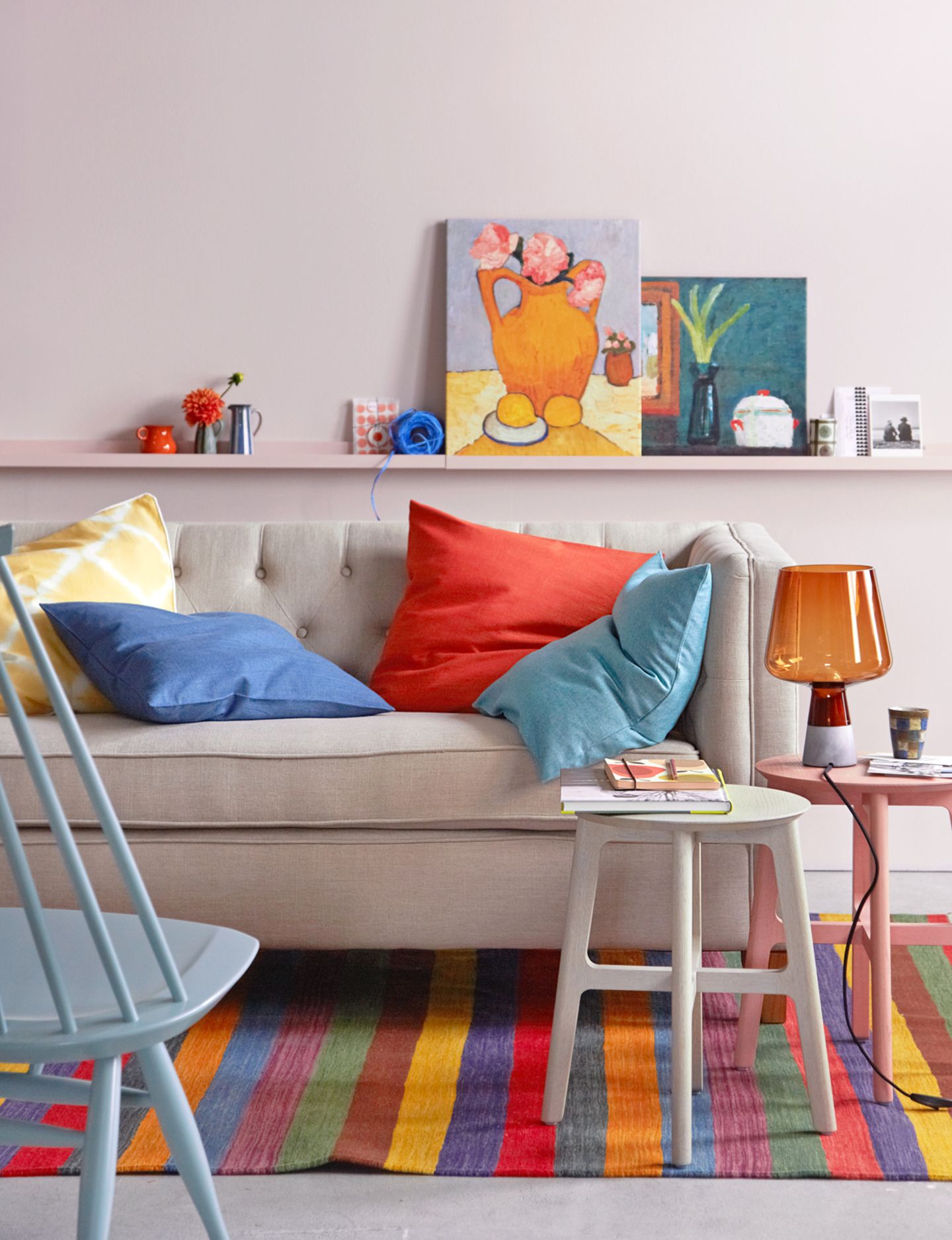 Sofa in Naturweiß vor Wand in Rosa mit Bilderleiste