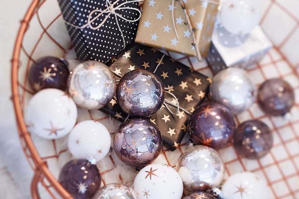 Weihnachtskugeln mit Sternen von Gingar in einem Drahtkorb mit Geschenken