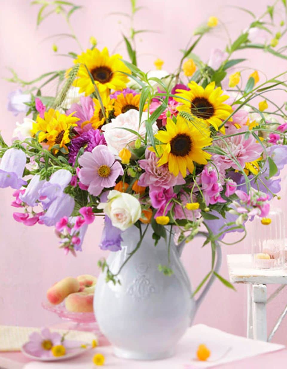 Dieser Blumenstrauß mit Sonnenblumen, Zinnien und Dahlien verbindet Schlichtheit mit Verspieltheit und lässt eine unbeschwerte Sommerathmosphäre aufkommen.