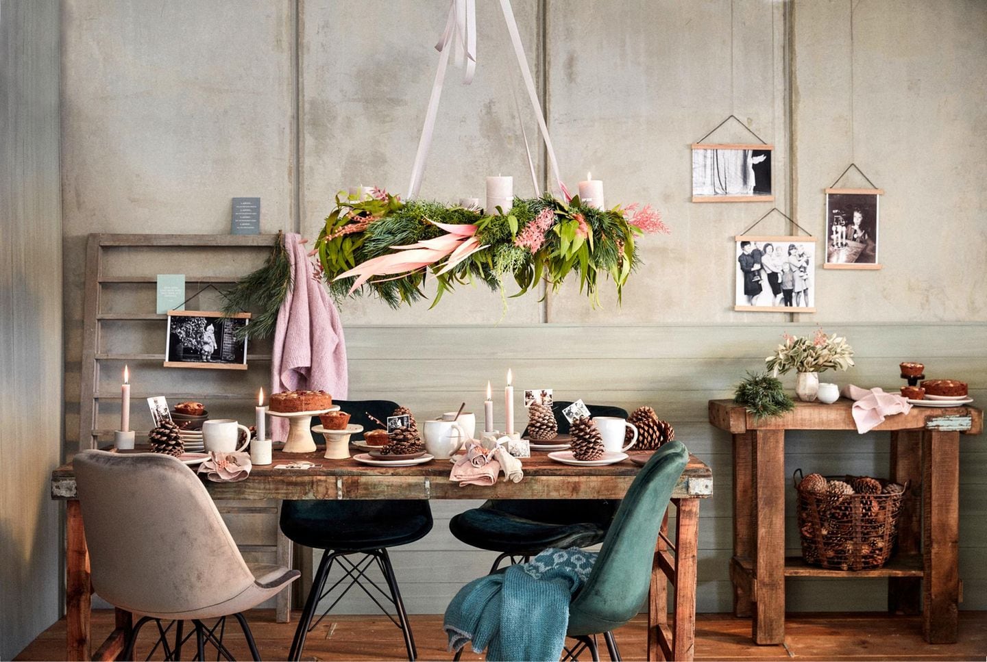 Über einem rustikalen Holztisch schwebt ein prachtvoller Adventskranz aus Tannengrün